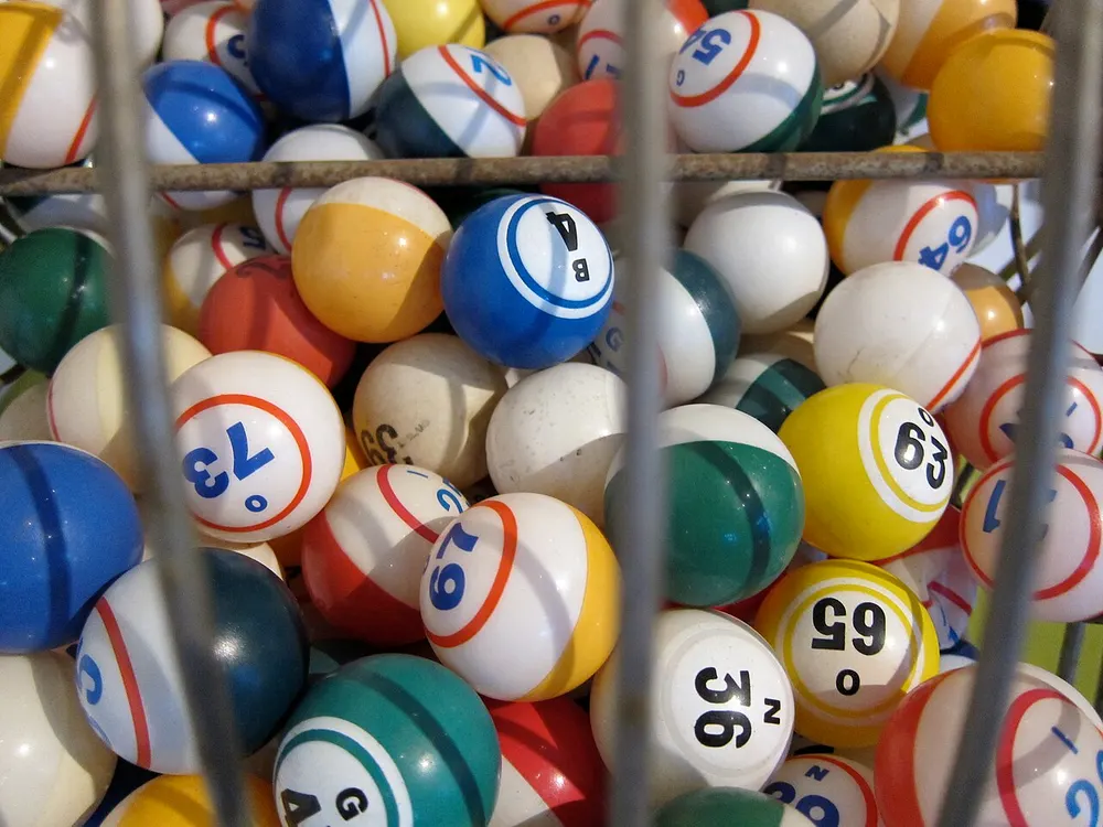 Numbered balls tumbling inside a bingo drum